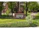 Stone entrance sign to Ironstone at Stroh Ranch surrounded by landscaped greenery and trees at 12914 Ironstone Way # 102, Parker, CO 80134