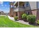 Charming condo exterior with a private covered patio and lush green lawn at 12914 Ironstone Way # 102, Parker, CO 80134
