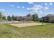Sand volleyball court next to a community building surrounded by lush green lawns and trees at 12914 Ironstone Way # 102, Parker, CO 80134
