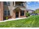 Inviting condo with brick and siding exterior, covered patio, and well-maintained landscaping at 12914 Ironstone Way # 102, Parker, CO 80134