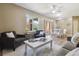 Spacious living room showcasing a blend of seating and natural light at 12914 Ironstone Way # 102, Parker, CO 80134