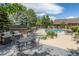 Outdoor community pool area with hot tub, grills, and seating at 12914 Ironstone Way # 102, Parker, CO 80134