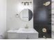 Modern bathroom featuring a stylish vanity, fixtures, and shower with contrasting tile, offering a chic and functional space at 785 Planet Pl, Thornton, CO 80260