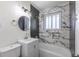 Modern bathroom with sleek fixtures, stylish tile, and a bathtub, creating a luxurious and relaxing space at 785 Planet Pl, Thornton, CO 80260