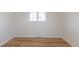 Bedroom featuring hardwood floors, a window, and neutral paint, offering a peaceful and adaptable space at 785 Planet Pl, Thornton, CO 80260