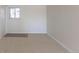 Cozy bedroom featuring neutral carpeting, light walls, and a window at 785 Planet Pl, Thornton, CO 80260