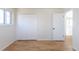 Bedroom featuring hardwood floors, a window, closet, and neutral paint, creating a soothing and flexible environment at 785 Planet Pl, Thornton, CO 80260