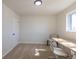 Neutral-toned bedroom with carpet, a window, and a closet door, creating a serene atmosphere at 785 Planet Pl, Thornton, CO 80260