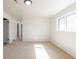 Bright bedroom featuring neutral carpeting, light walls, and a window providing natural light at 785 Planet Pl, Thornton, CO 80260