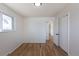 Bedroom featuring hardwood floors, a window, closet, and neutral paint, providing a cozy and adaptable space at 785 Planet Pl, Thornton, CO 80260