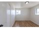 Bedroom with hardwood floors, a window, closet, and neutral paint, offering a bright and inviting space at 785 Planet Pl, Thornton, CO 80260