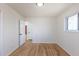 Bedroom featuring hardwood floors, a window, closet, and neutral paint, providing a serene and customizable area at 785 Planet Pl, Thornton, CO 80260