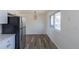 Dining area featuring a stylish light fixture, new floors and plenty of light at 785 Planet Pl, Thornton, CO 80260