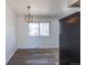 Dining room featuring modern chandelier, new flooring and plenty of natural light at 785 Planet Pl, Thornton, CO 80260