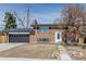 Charming brick home with a well-maintained front yard and attached garage at 785 Planet Pl, Thornton, CO 80260