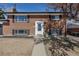 Charming front exterior of a two-story brick home with a well-manicured lawn and walkway at 785 Planet Pl, Thornton, CO 80260