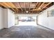 Large garage featuring a concrete floor with an open overhead door to the exterior at 785 Planet Pl, Thornton, CO 80260