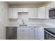 Updated kitchen with white cabinets, stainless steel appliances, and subway tile backsplash at 785 Planet Pl, Thornton, CO 80260