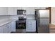 Modern kitchen featuring stainless steel appliances and sleek white cabinetry at 785 Planet Pl, Thornton, CO 80260