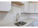 Bright kitchen with stainless steel sink, white countertops, and subway tile backsplash at 785 Planet Pl, Thornton, CO 80260
