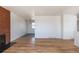 Open living area with hardwood floors and brick fireplace feature at 785 Planet Pl, Thornton, CO 80260
