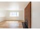 Bright living room with hardwood floors, brick fireplace, and a large window letting in ample natural light at 785 Planet Pl, Thornton, CO 80260