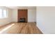 Bright living room with a brick fireplace and hardwood floors at 785 Planet Pl, Thornton, CO 80260