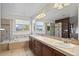 Elegant bathroom featuring a shower, soaking tub, double sinks, generous counter space, and natural light for a refreshing feel at 16823 Weber Way, Mead, CO 80542