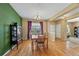 Elegant dining room featuring hardwood floors, a chandelier, and a large window at 16823 Weber Way, Mead, CO 80542