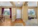 Bright foyer with hardwood floors, leading to carpeted living areas and multiple windows at 16823 Weber Way, Mead, CO 80542