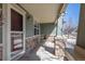 Inviting covered front porch with brick pillars and seating area, perfect for relaxing at 16823 Weber Way, Mead, CO 80542