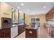 Bright kitchen with a central island, granite countertops, modern appliances, and an adjacent living and dining area at 16823 Weber Way, Mead, CO 80542