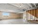 Spacious unfinished basement featuring natural light and stairs ready to be finished at 9099 Pitkin St, Commerce City, CO 80022