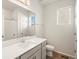 Well-lit bathroom with a white vanity, sleek fixtures, and modern finishes at 9099 Pitkin St, Commerce City, CO 80022