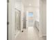 Neutral bathroom showcasing a walk-in shower with glass doors, a single sink, and access to another room at 9099 Pitkin St, Commerce City, CO 80022