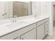 Bathroom featuring double sinks, white quartz countertops, and a walk-in shower with glass doors at 9099 Pitkin St, Commerce City, CO 80022