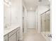 Bathroom featuring a glass-enclosed shower and light gray cabinetry at 9099 Pitkin St, Commerce City, CO 80022