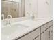 Bright bathroom featuring a double vanity with sleek countertops and modern fixtures at 9099 Pitkin St, Commerce City, CO 80022