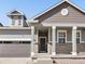 Attractive front exterior showcasing architectural details, columns, and a well-maintained lawn at 9099 Pitkin St, Commerce City, CO 80022