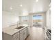 Spacious kitchen featuring hardwood flooring, a center island and stainless appliances at 9099 Pitkin St, Commerce City, CO 80022