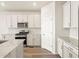 Well-lit kitchen featuring stainless appliances, granite countertops, and hardwood flooring at 9099 Pitkin St, Commerce City, CO 80022