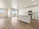 Open-concept kitchen featuring stainless appliances, ample cabinet space, and bright natural light at 9099 Pitkin St, Commerce City, CO 80022
