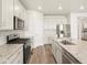Updated kitchen featuring a center island, modern stainless appliances, and stylish cabinetry at 9099 Pitkin St, Commerce City, CO 80022