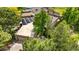 Aerial view of the residence highlighting the home's roof, solar panels, mature trees, and lush surroundings at 7300 W Stetson Pl # 46, Littleton, CO 80123