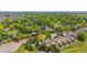 An aerial view of a neighborhood showcasing tree-lined streets, solar panels, and mature landscaping with city views at 7300 W Stetson Pl # 46, Littleton, CO 80123