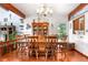 Large dining room with wood floors, table set for ten, and built-in hutch display at 7300 W Stetson Pl # 46, Littleton, CO 80123