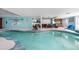 Large, bright indoor pool surrounded by living space, featuring a unique design and entertainment options at 7300 W Stetson Pl # 46, Littleton, CO 80123