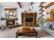 Comfortable living room with fireplace, entertainment center, wood beams, and cat stairs at 7300 W Stetson Pl # 46, Littleton, CO 80123