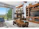Cozy living room featuring a fireplace, large entertainment center, and outdoor lake views at 7300 W Stetson Pl # 46, Littleton, CO 80123