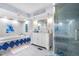 Bathroom featuring a glass shower, tub, and white vanity with blue accent tiles and fixtures at 7300 W Stetson Pl # 46, Littleton, CO 80123
